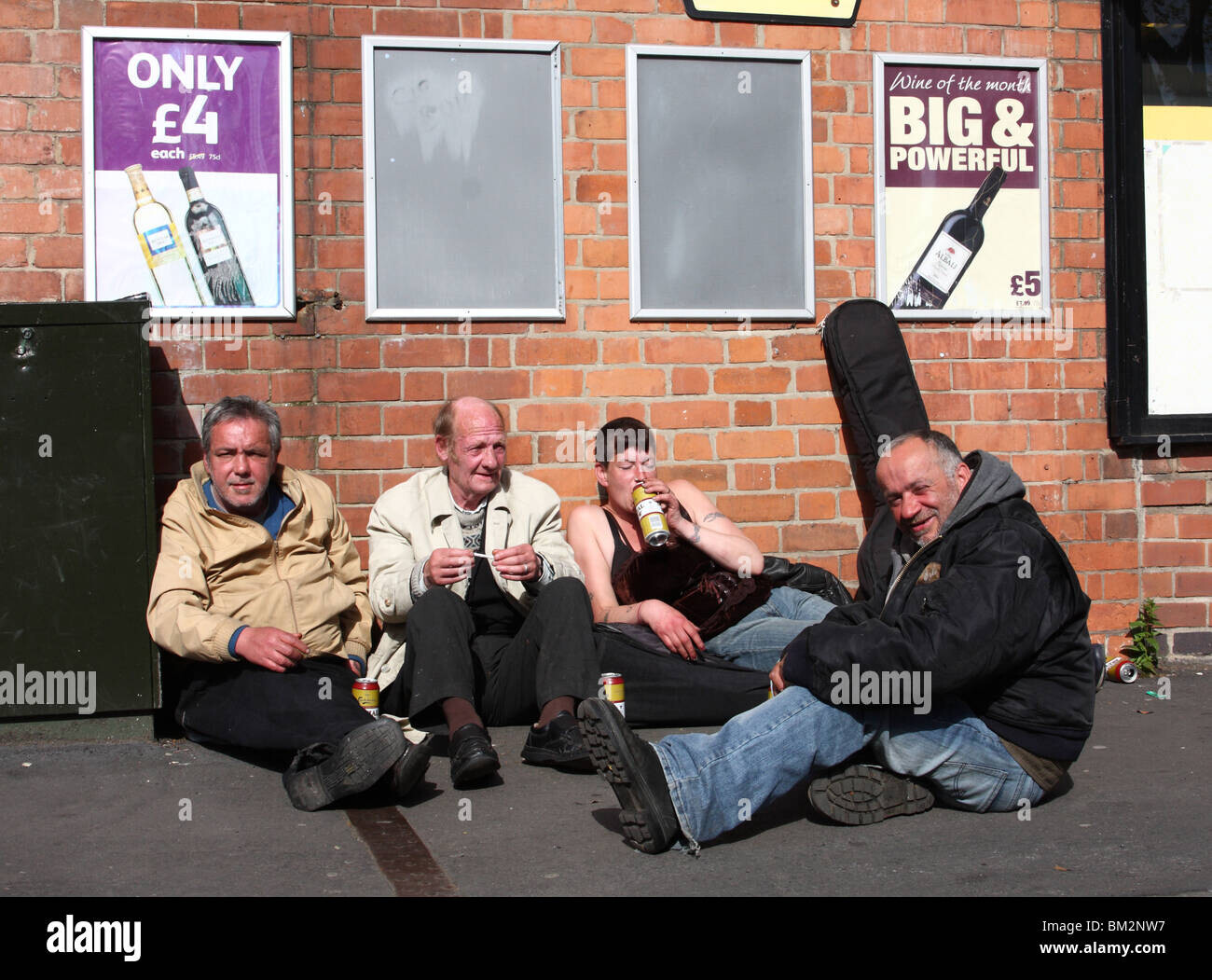 homeless-people-drinking-alcohol-beneath-posters-advertising-cheap-BM2NW7.jpg.c1e25bf6c86c2a2c2bb533d73a12cf44.jpg